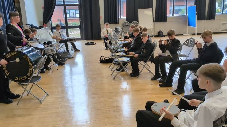 Ashfield Boys School Flute Band rehearsing with flutes and drums indoors
