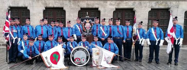 The Loyal Flute Band group photograph with drums, flags and banners